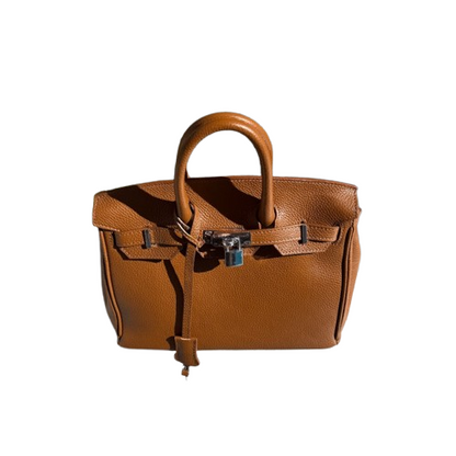 Bolso de piel de mano y cierre metálico.