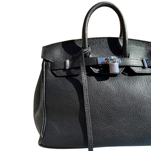 Bolso de piel de mano y cierre metálico.