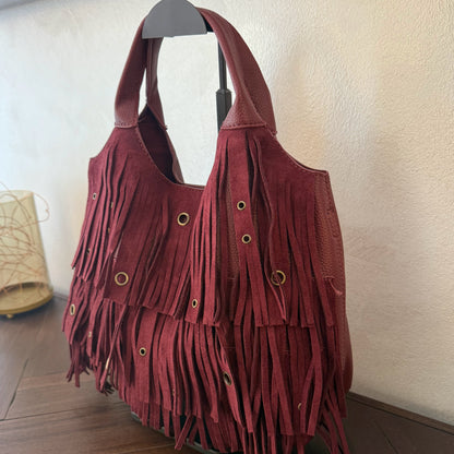 Bolso de mano con asa larga de flecos y aros metálicos